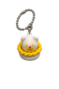 Keychain with a white bear-like character wearing a yellow rope around its neck on a white background