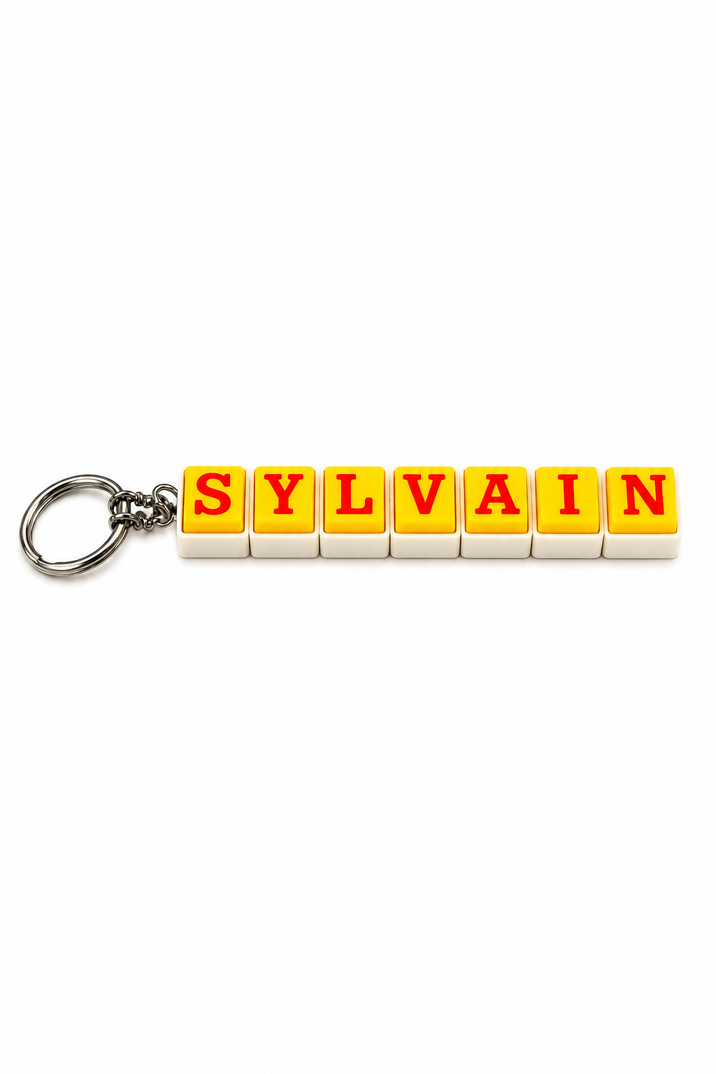 Keychain with colorful letter blocks spelling 'SYLVAIN' on a white background
